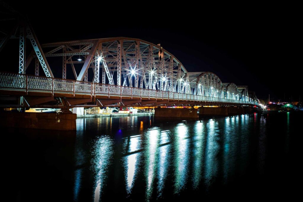 The Sturgeon Bay steel bridge lit at night over dark water