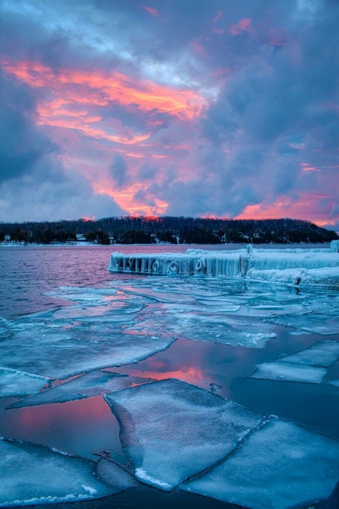 Ice chunks on a frozen Lake Michigan catching a pink sunset, Door County