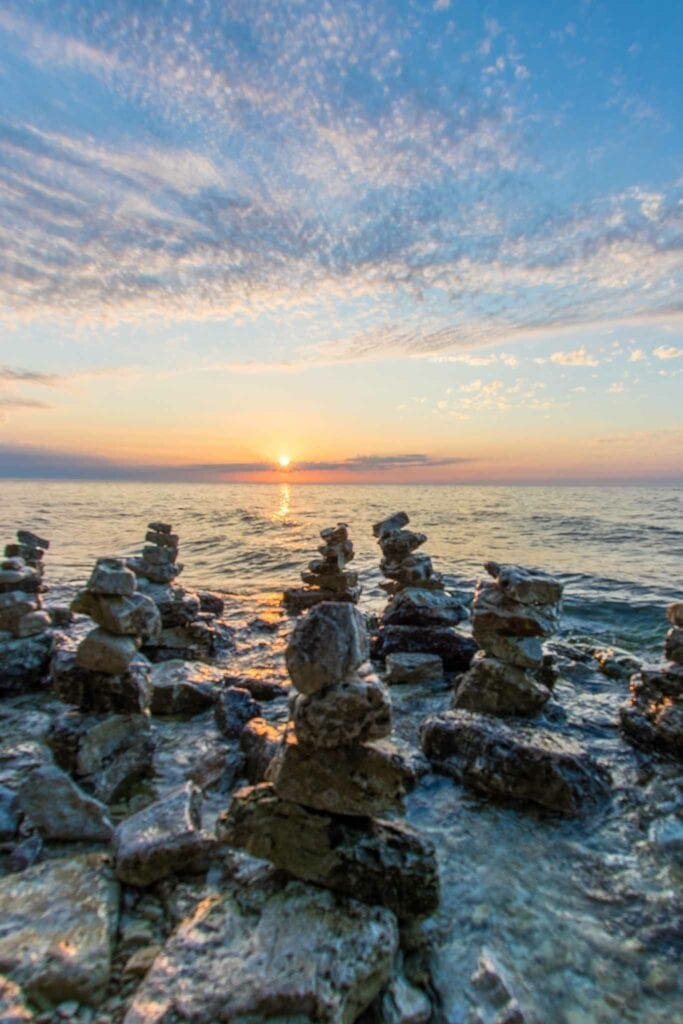 Stacked stones on a rocky Door County shoreline at sunset