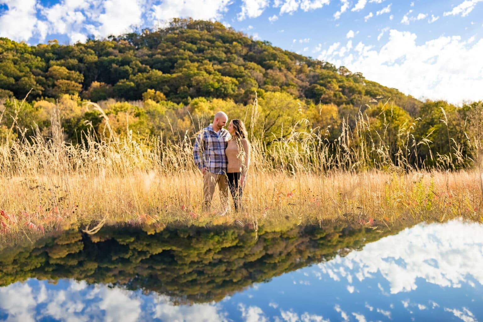 An engaged couple reflected in still backwater under the bluffs at Perrot State Park, Trempealeau