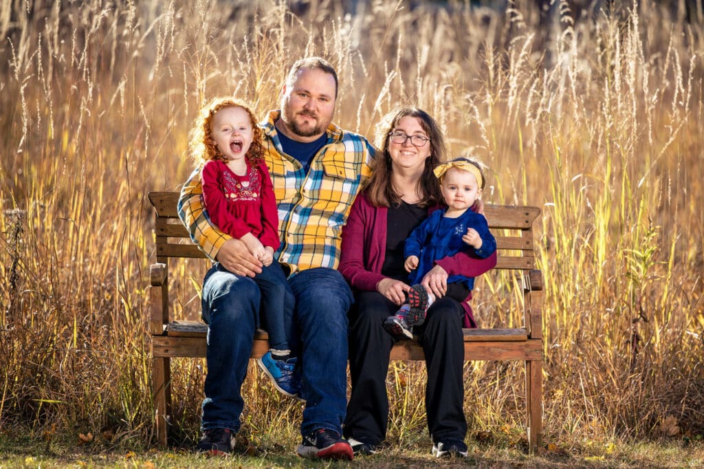 Myrick Park family on bench by Photographer Jeff Wiswell of J.L. Wiswell Photography