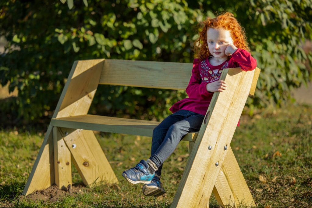 Myrick Park girl on bench by Photographer Jeff Wiswell of J.L. Wiswell Photography