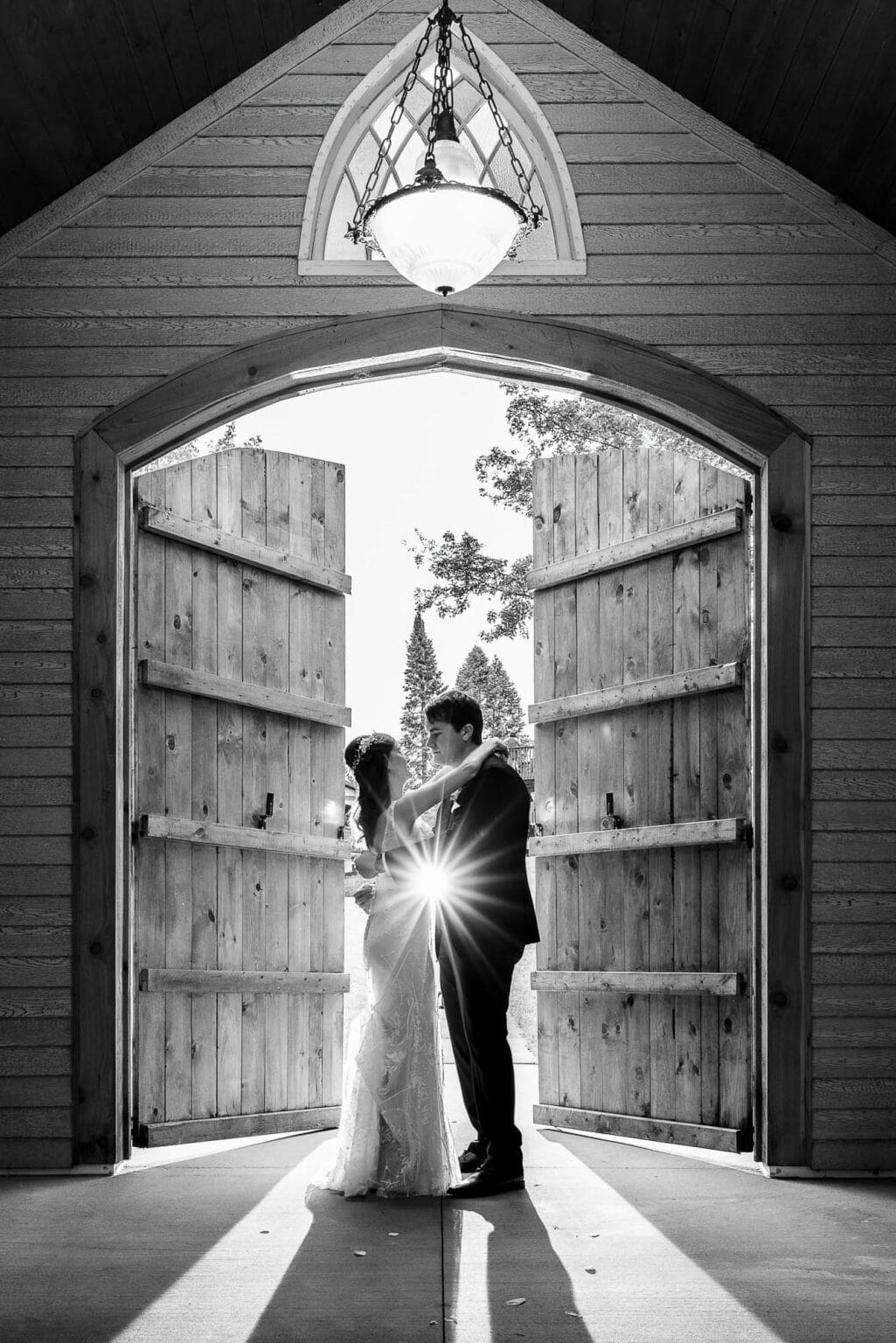 Bride and groom framed in the chapel doors at Winnebago Springs, Caledonia, Minnesota