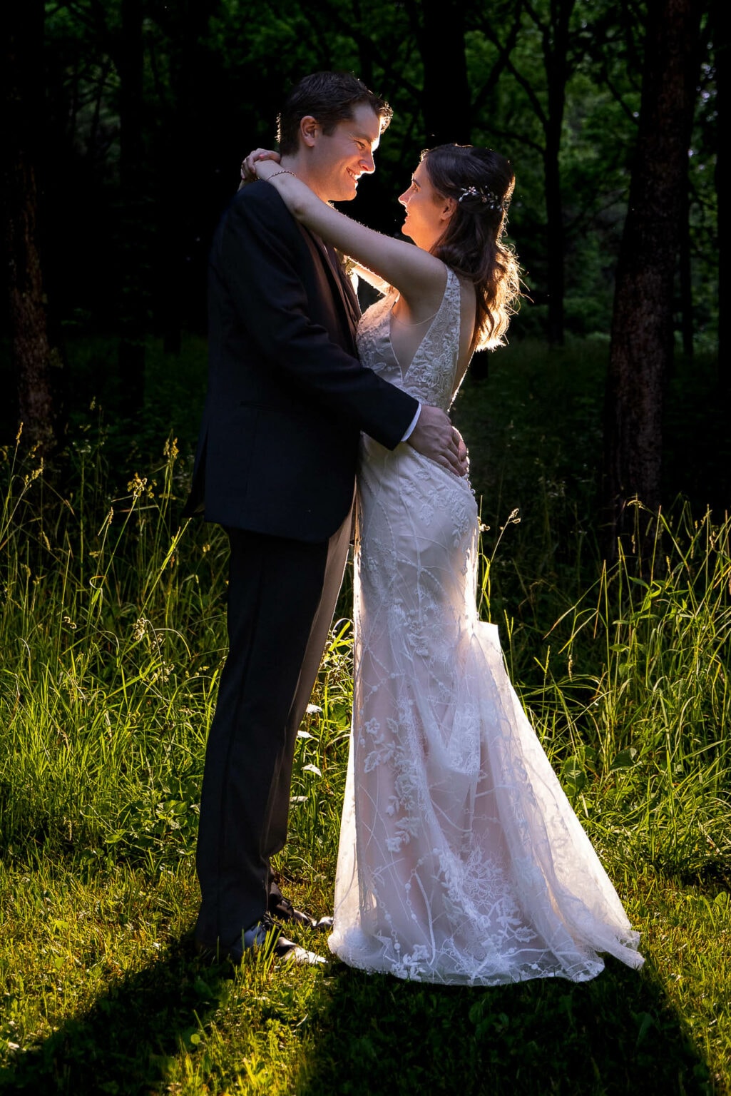 Bride and groom backlit in a field at Winnebago Springs, Caledonia, Minnesota