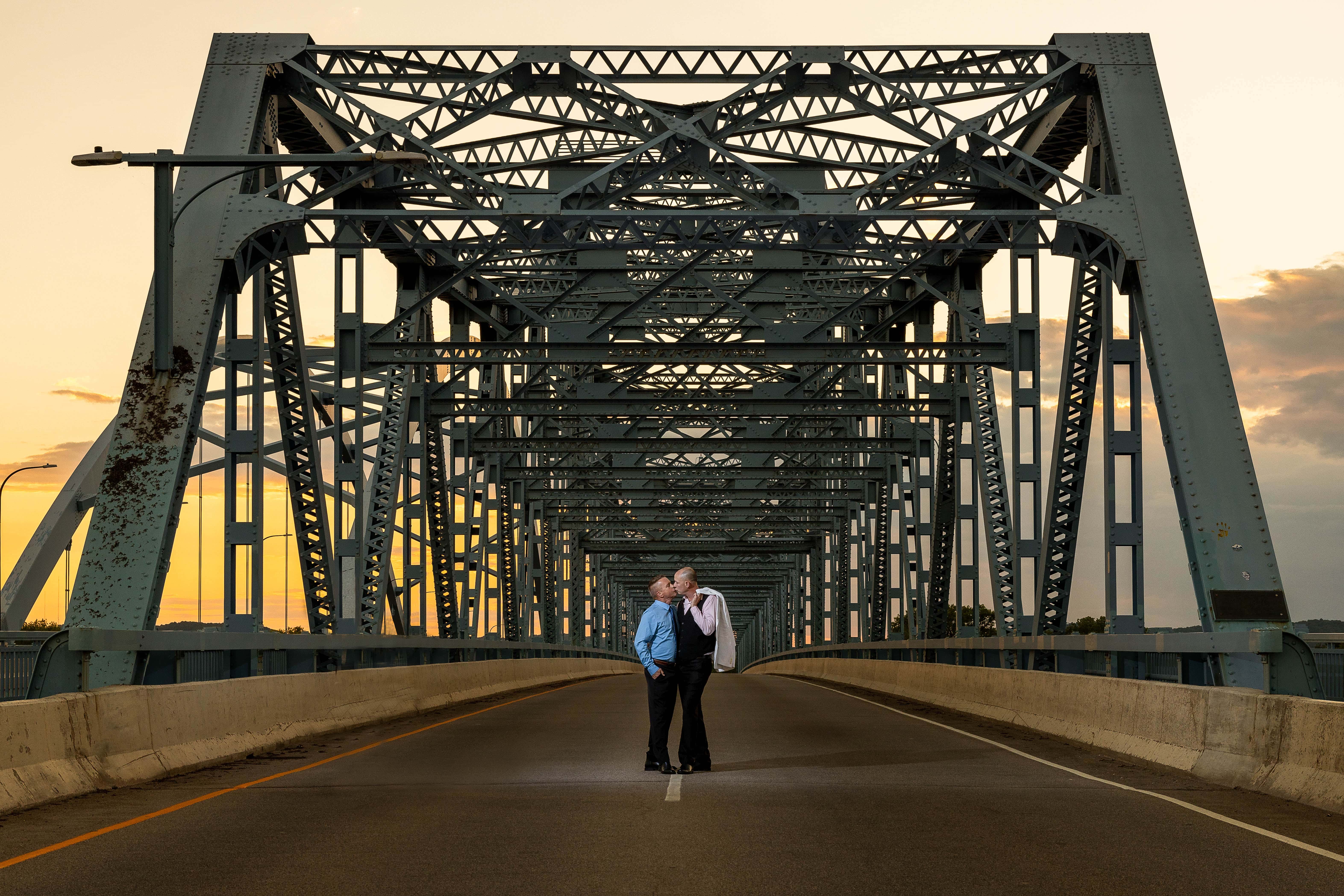 Couple kissing on Cass St. Bridge in La Crosse, WI by Jeff Wiswell of J.L. Wiswell Photography
