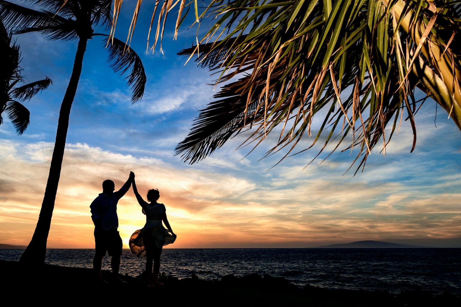 High-five at sunset on a tropical beach