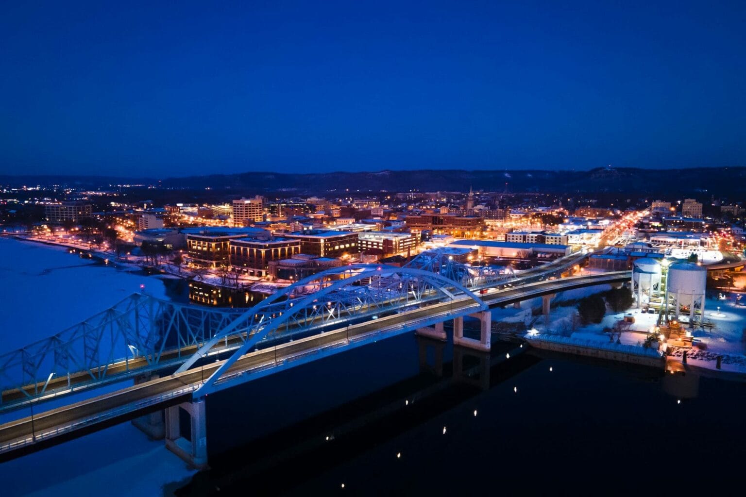 Downtown La Crosse and the bridges from the air at blue hour