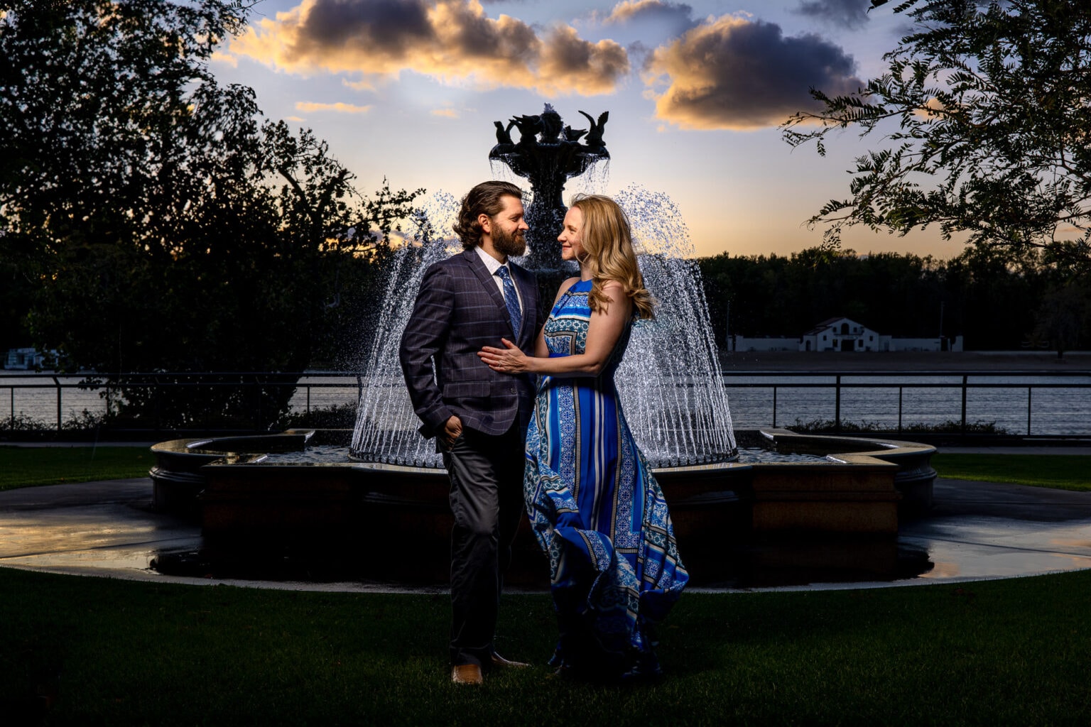 Couple by an illuminated fountain at dusk
