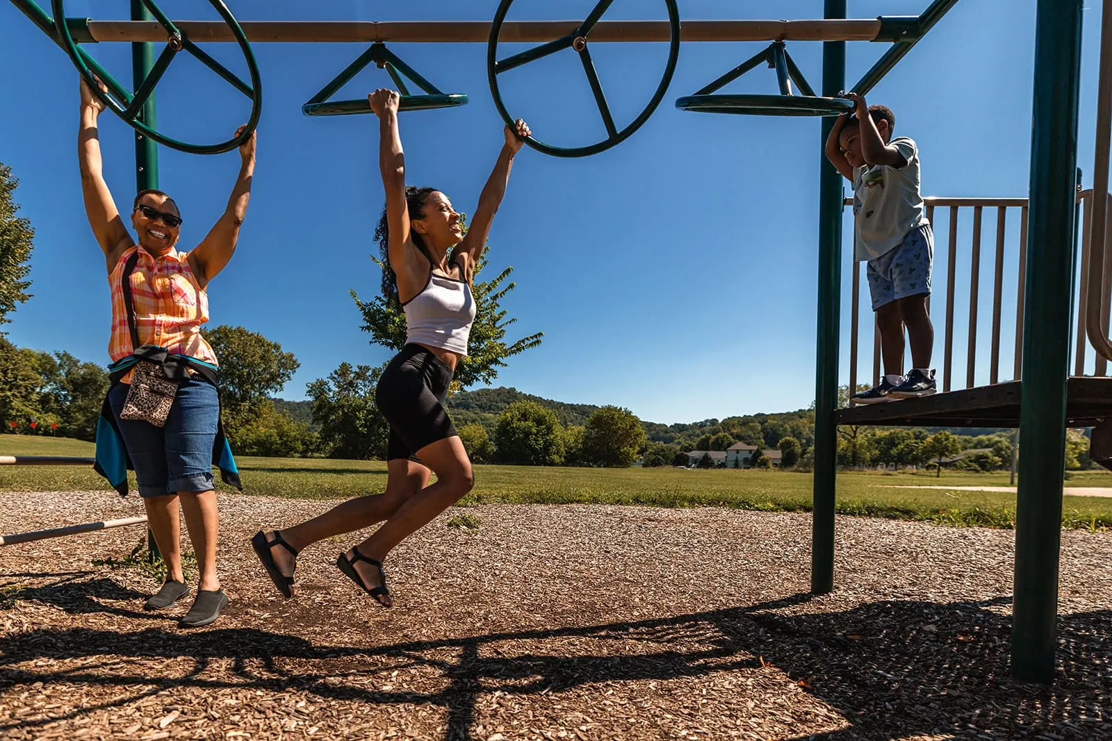Close-up of a parent holding a child's hand on the farm property, genuine connection