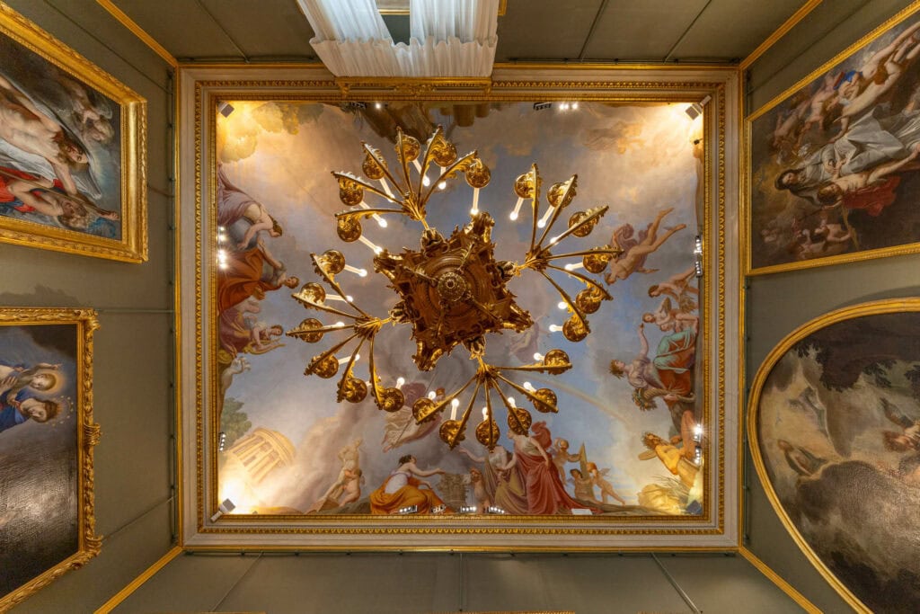 A ceiling fresco of golden cherubs radiating from a central sunburst, Florence