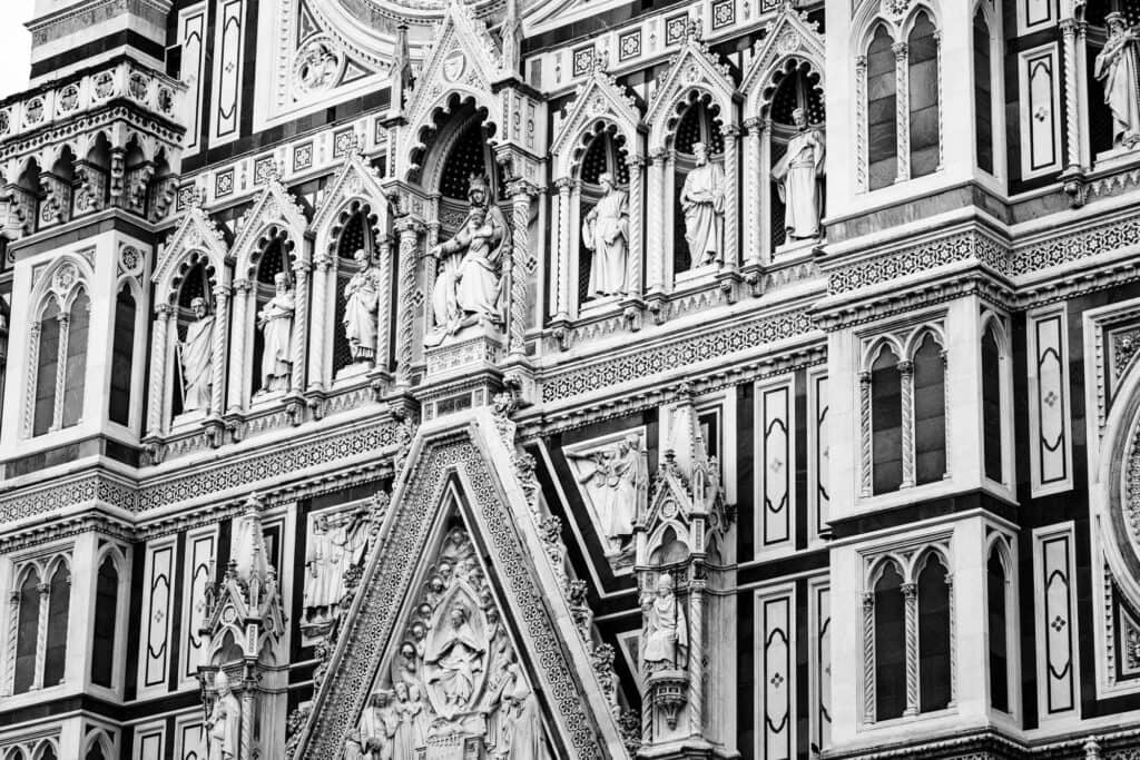 The Duomo's Gothic facade in black and white, marble inlay and pointed arches