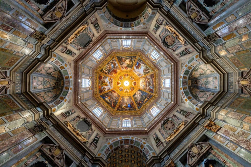 An octagonal dome ceiling with a golden fresco and geometric coffers, Florence