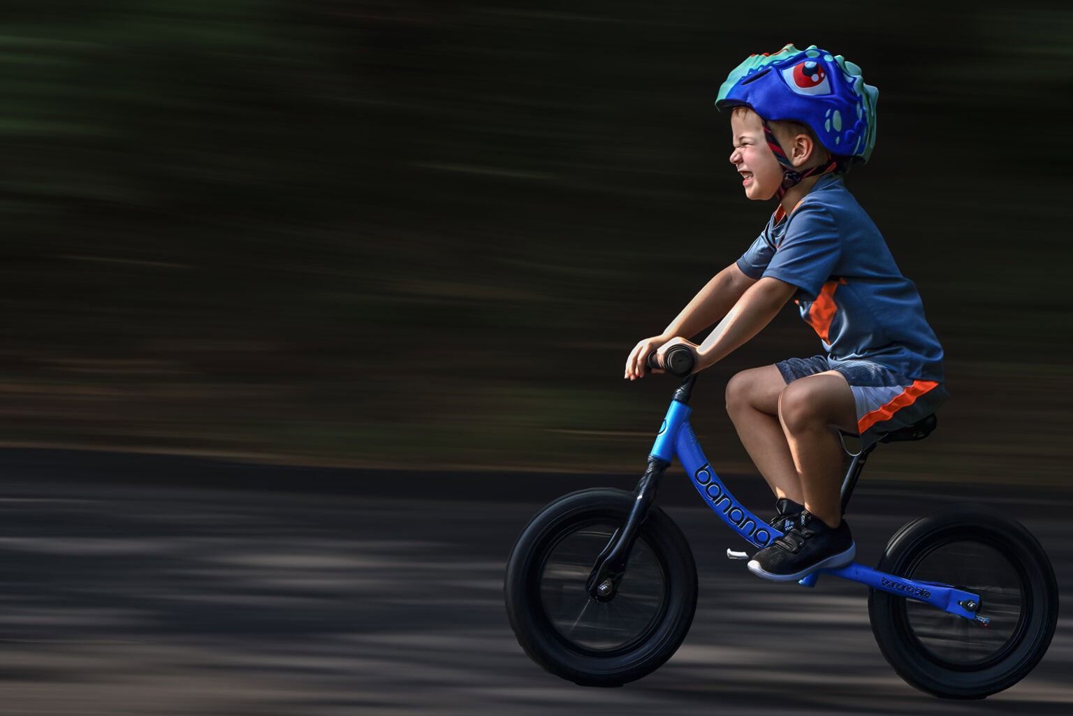 Boy riding a balance bike in motion