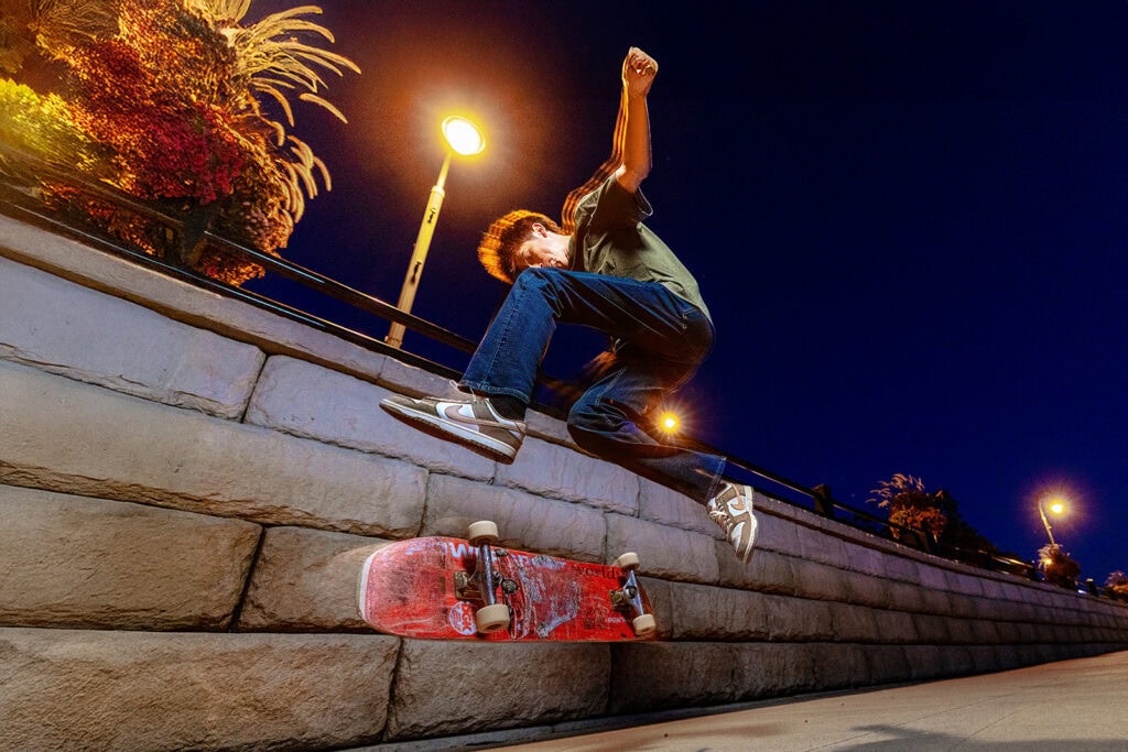 Emerson skateboarding down the riverfront steps at night in La Crosse