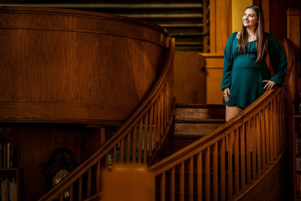 Candid-style senior photo of Claire exploring Pearl Street Books — by J.L. Wiswell Photography.