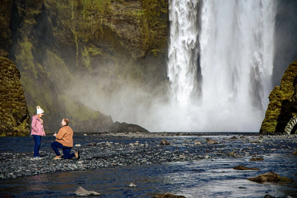 Couple after surprise proposal at Skógafoss in Iceland
