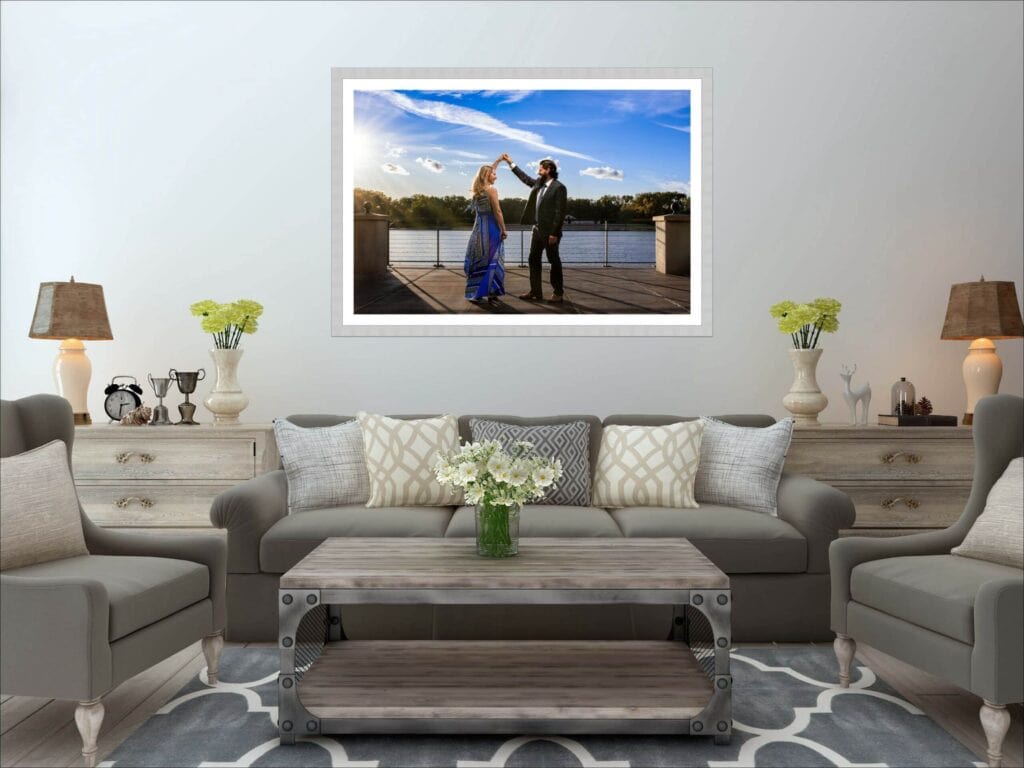 An engagement portrait on a lakeside deck, framed as wall art