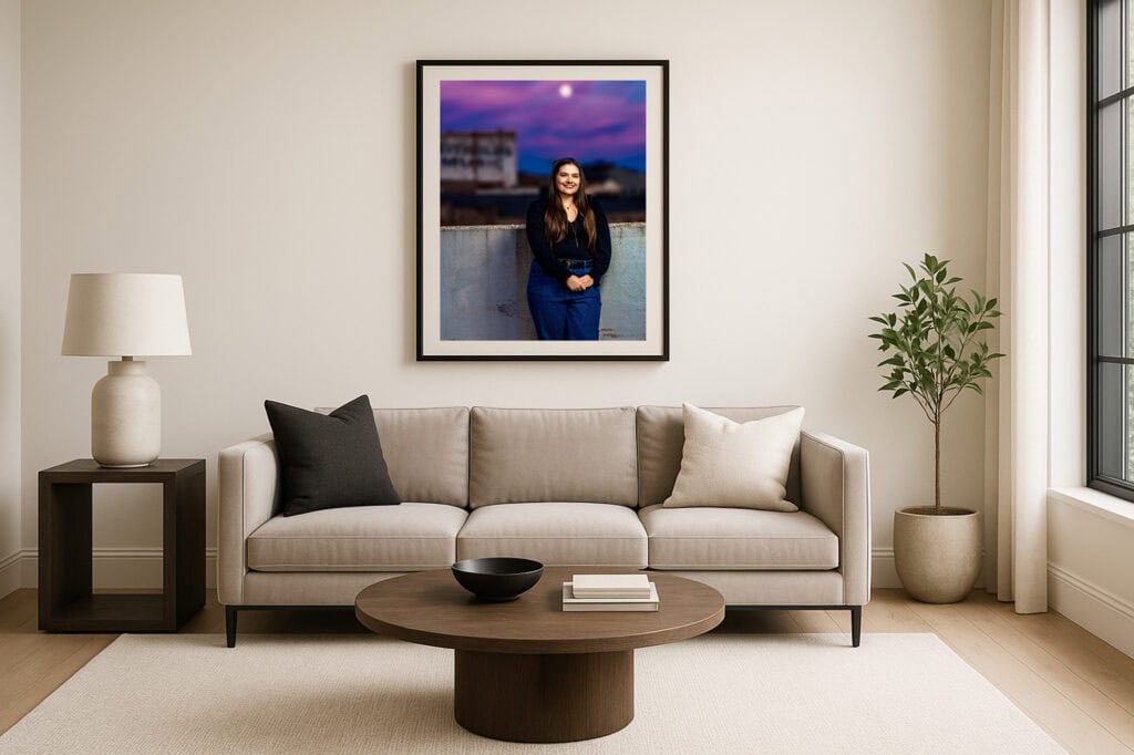 Framed senior portrait above the sofa, from Claire’s session