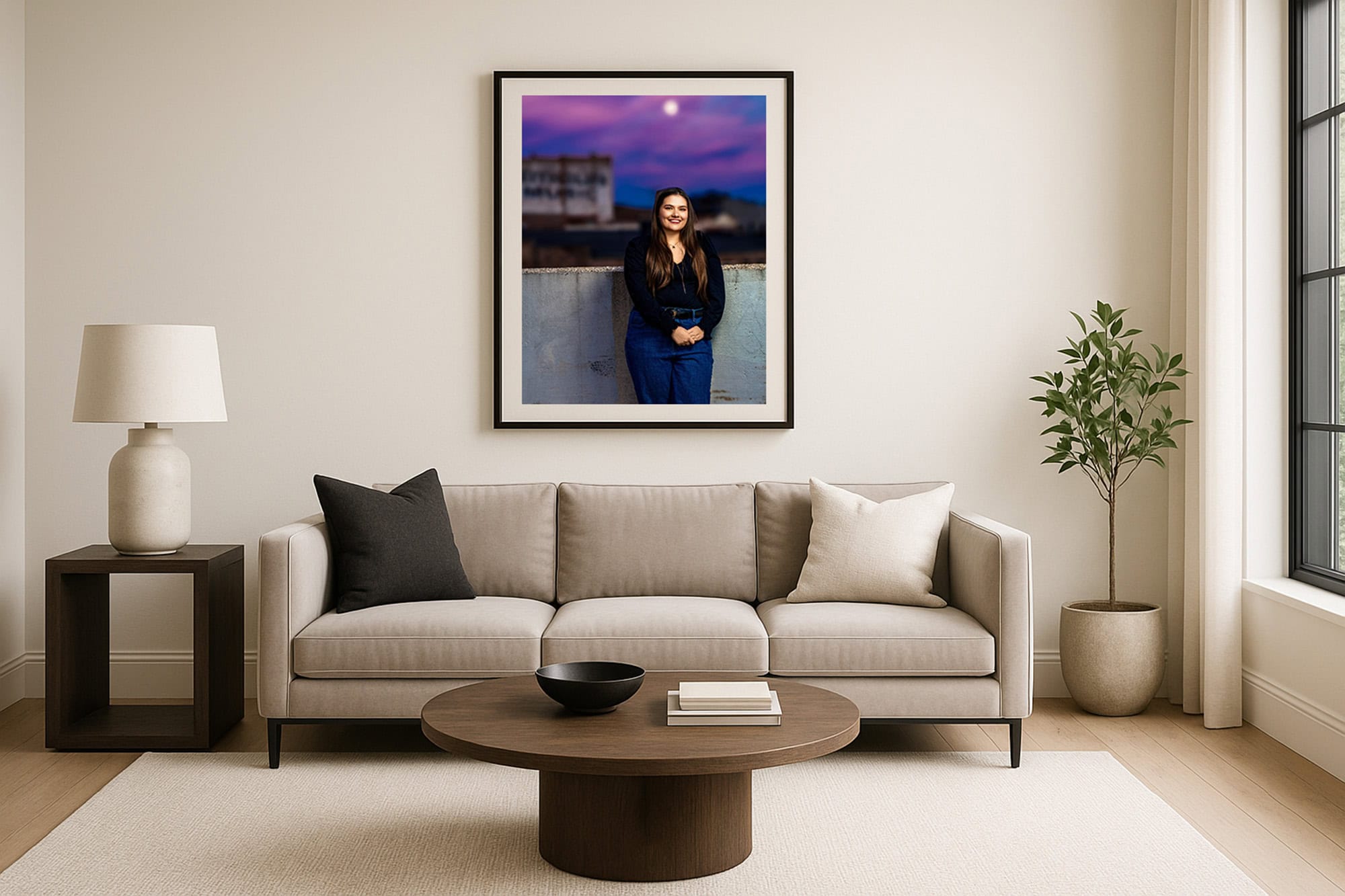 Framed senior portrait hanging above a living-room sofa