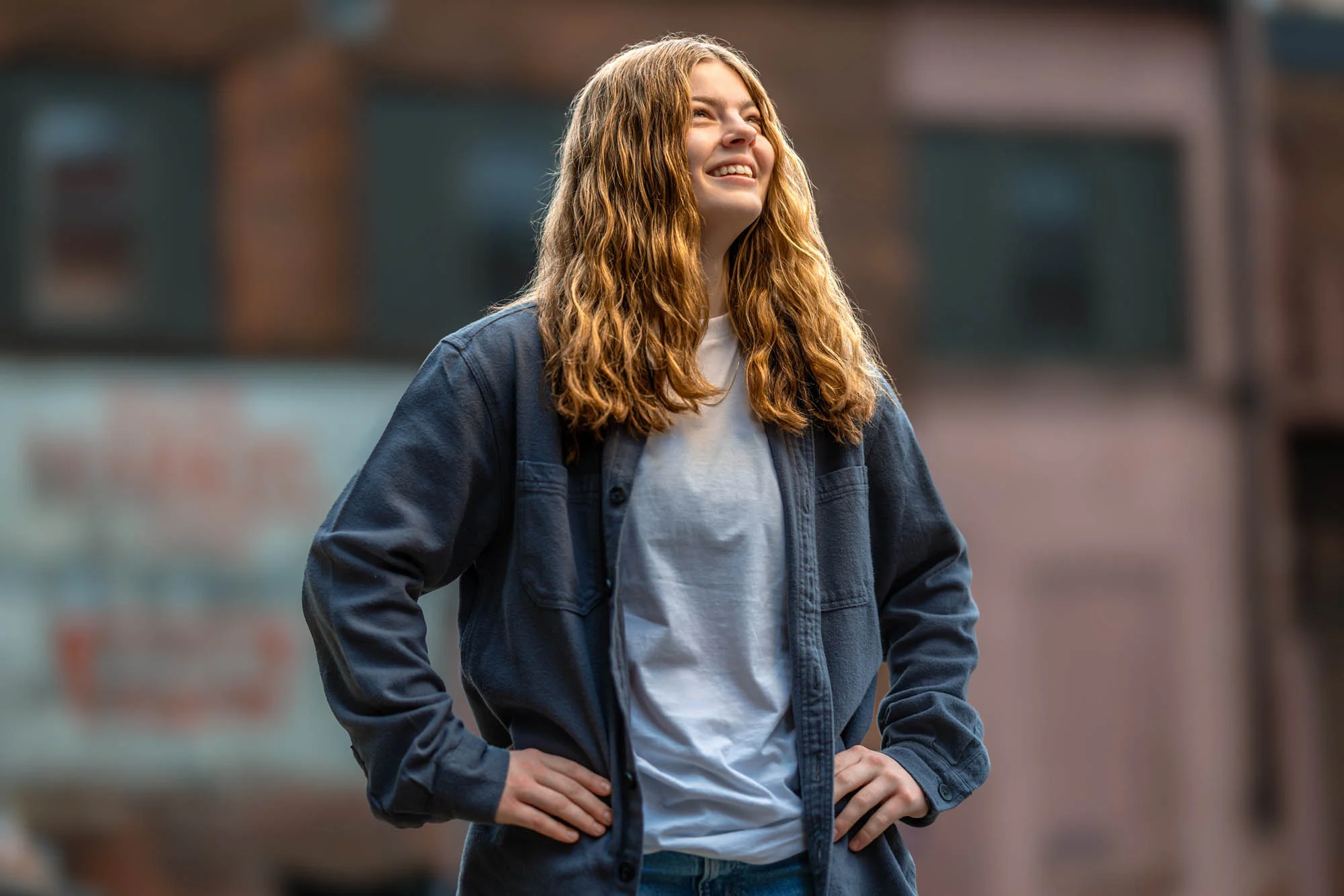 High school senior smiling confidently in downtown La Crosse, Wisconsin