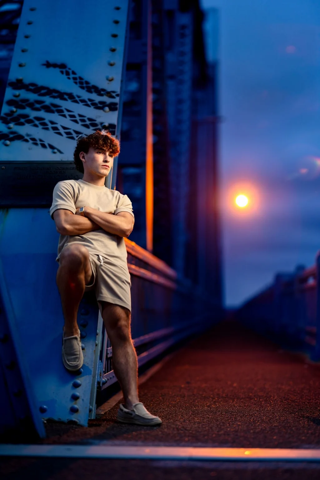 Deacon against the steel of the Cass Street Bridge at dusk under built light