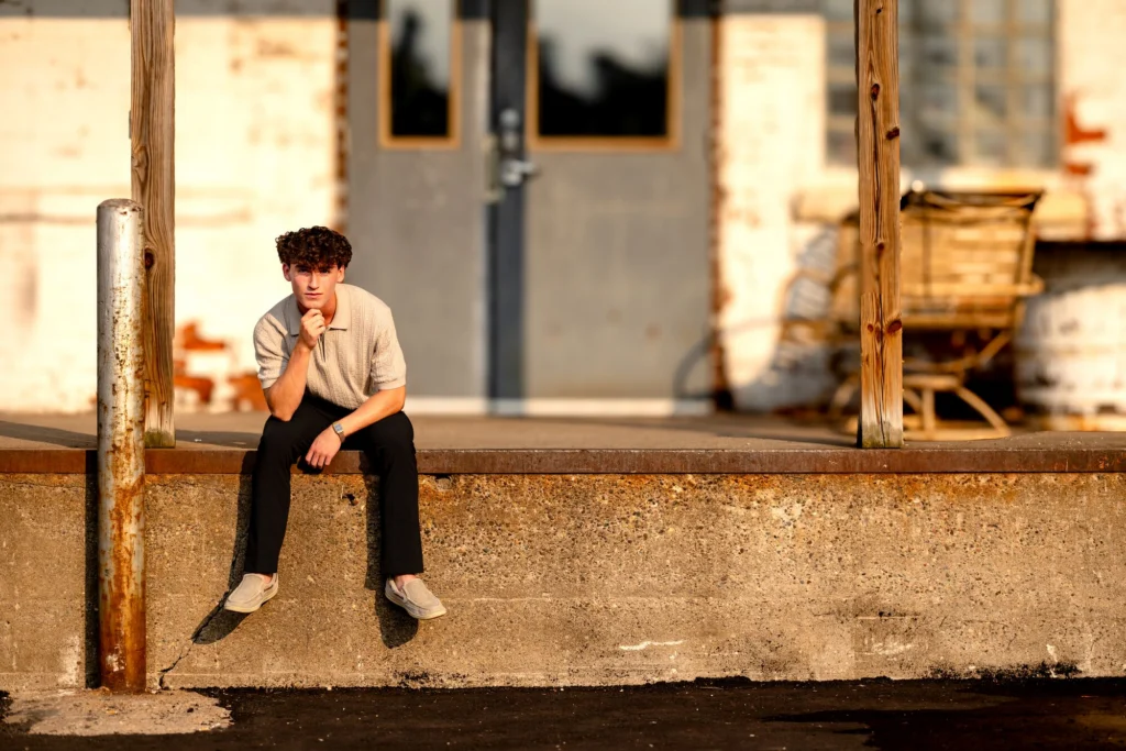 Deacon on a stone ledge in golden-hour light, downtown La Crosse