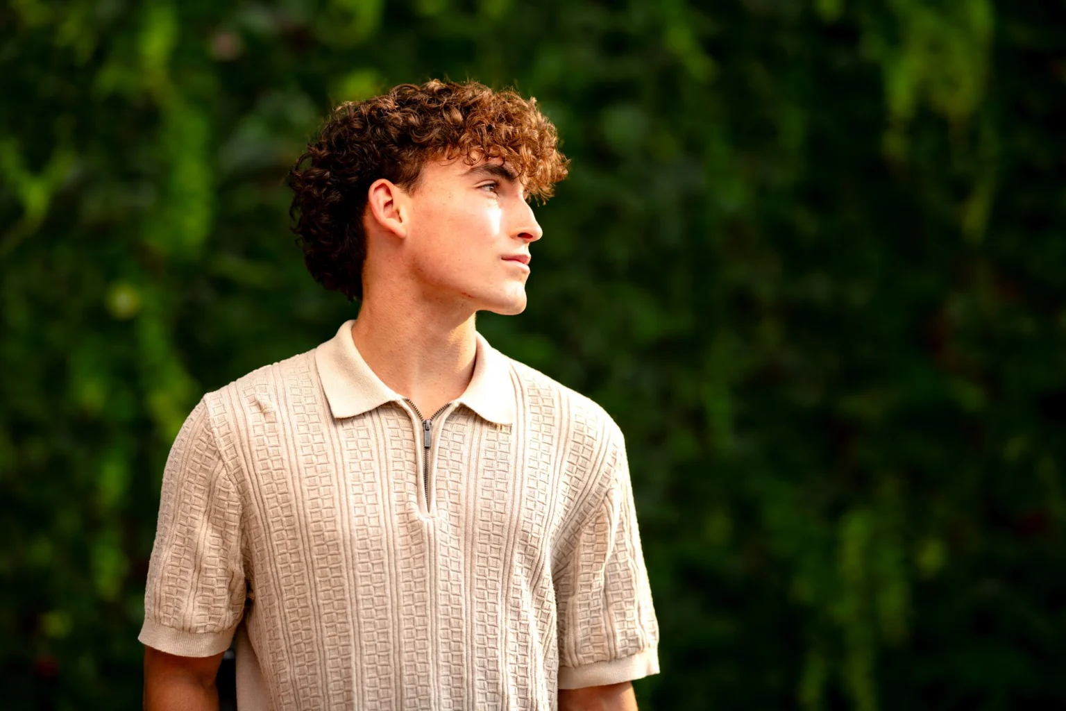 Deacon in profile against an ivy-covered wall, La Crosse