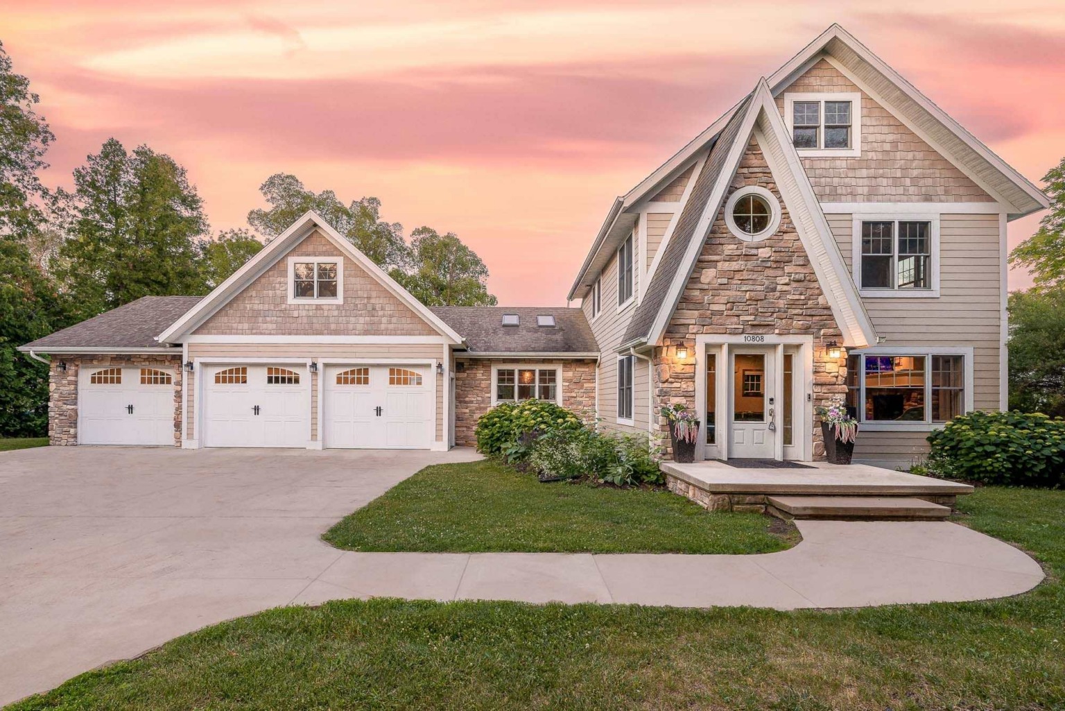 A Door County vacation home at twilight under a pink sky