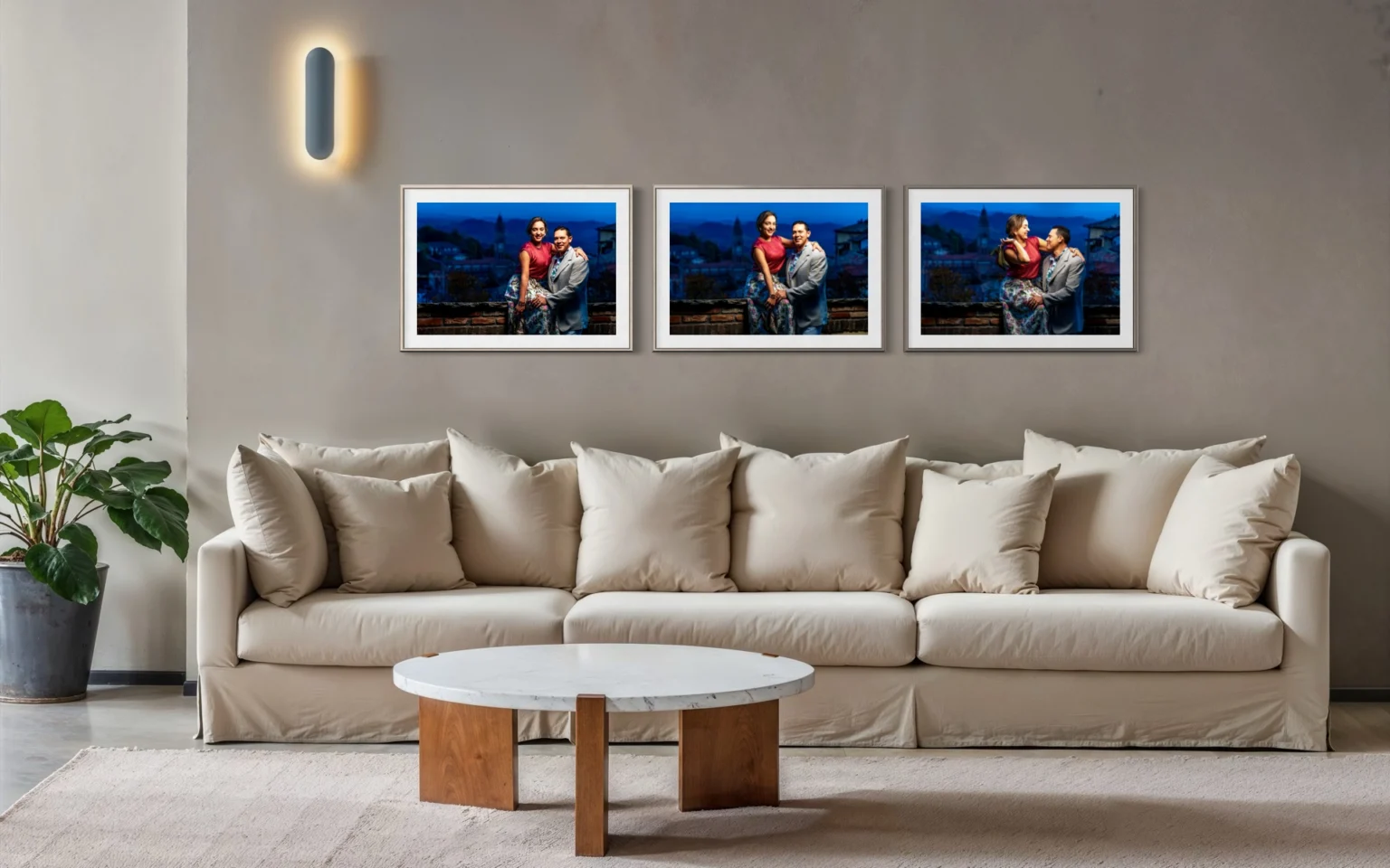 Three framed portraits of a couple above a sofa