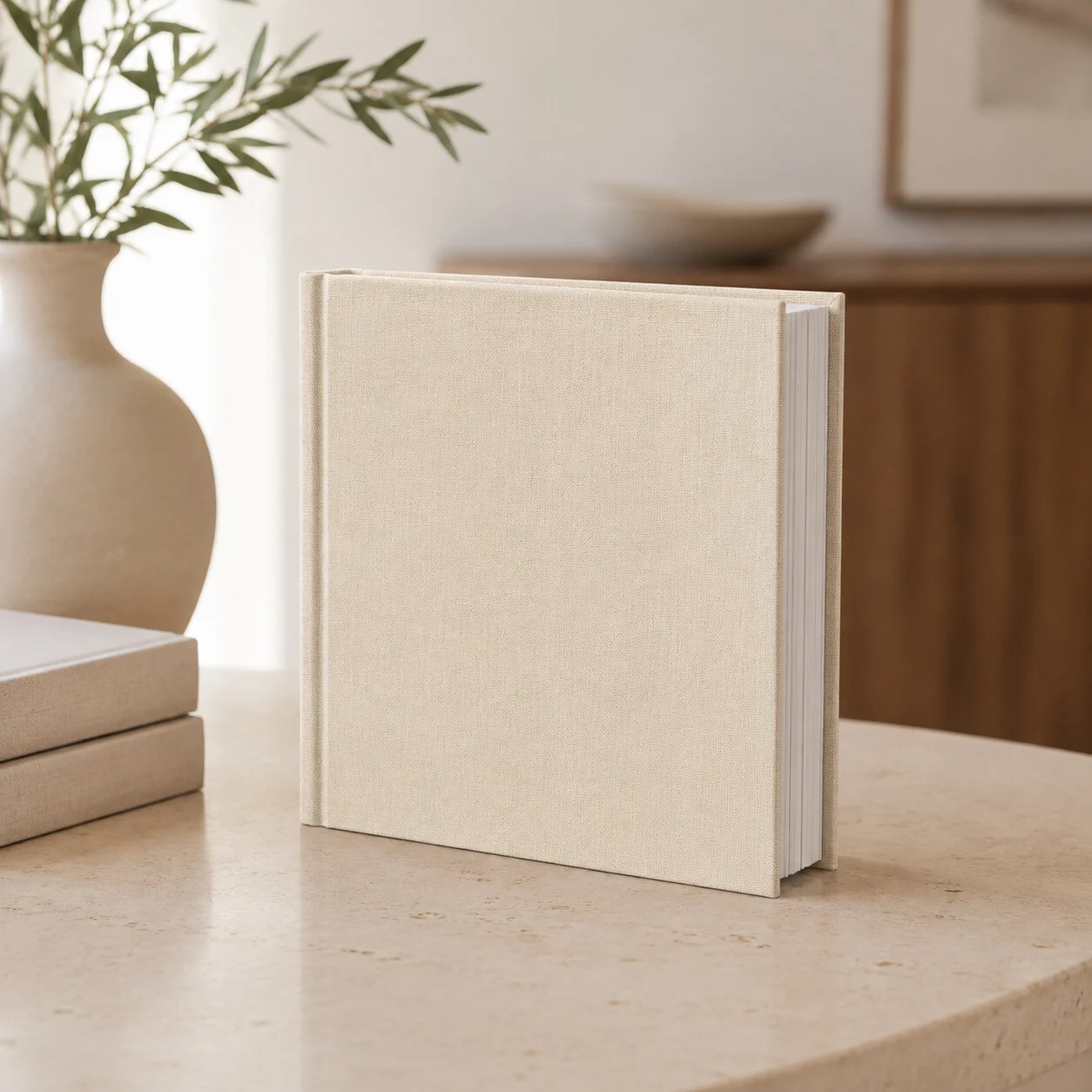 An 8 by 8 linen album standing on a travertine table